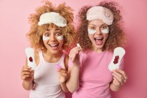 Duas Mulheres Alegres Com Produtos De Higiene Feminina E Absorventes.